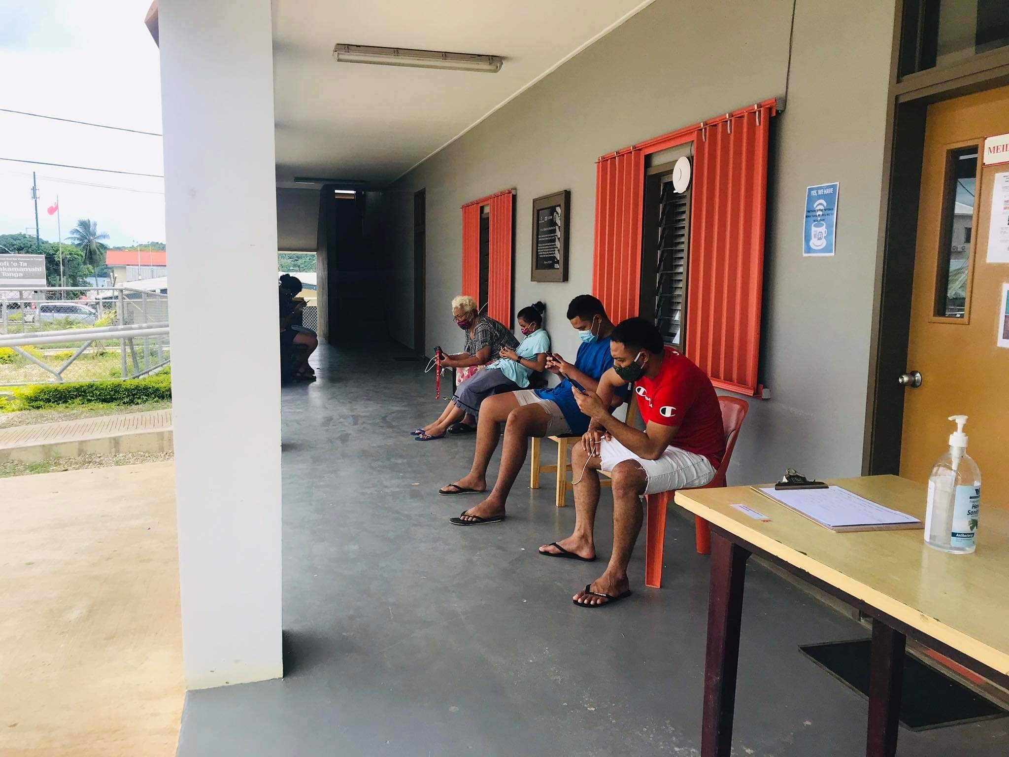 Members of the affected community in Vava’u wait outside the MEIDECC office for their turn in using the BGAN and satellite phones to contact loves ones in the aftermath of the disaster. Photo: Tonga NEMO
