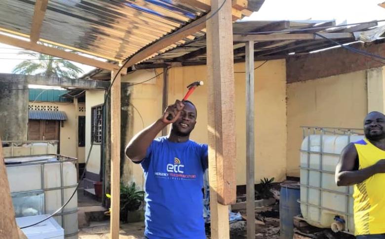 Lalou hammers home the finishing touches on an outdoor installation. Photo: ETC/WFP