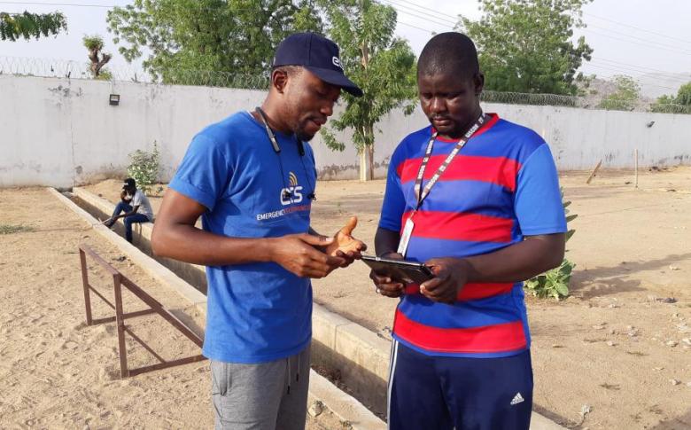 Before the COVID-19 pandemic: In his role as ETS IT Specialist, Caleb assists members of the humanitarian community