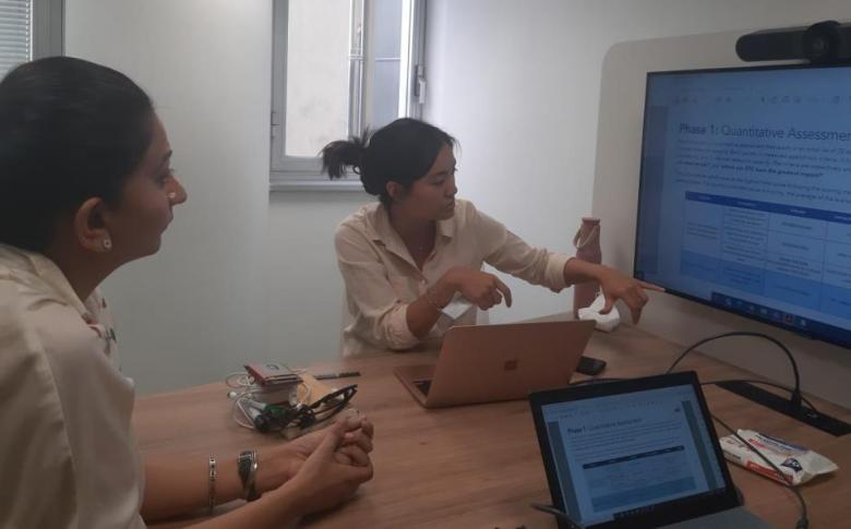 Phyza Jameel (left) listens as Jennifer Lim presents work at World Food Programme headquarters, Rome, Italy.